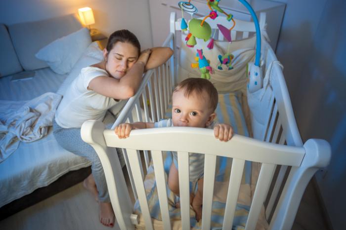 a-mother-sleeping-on-a-childs-crib